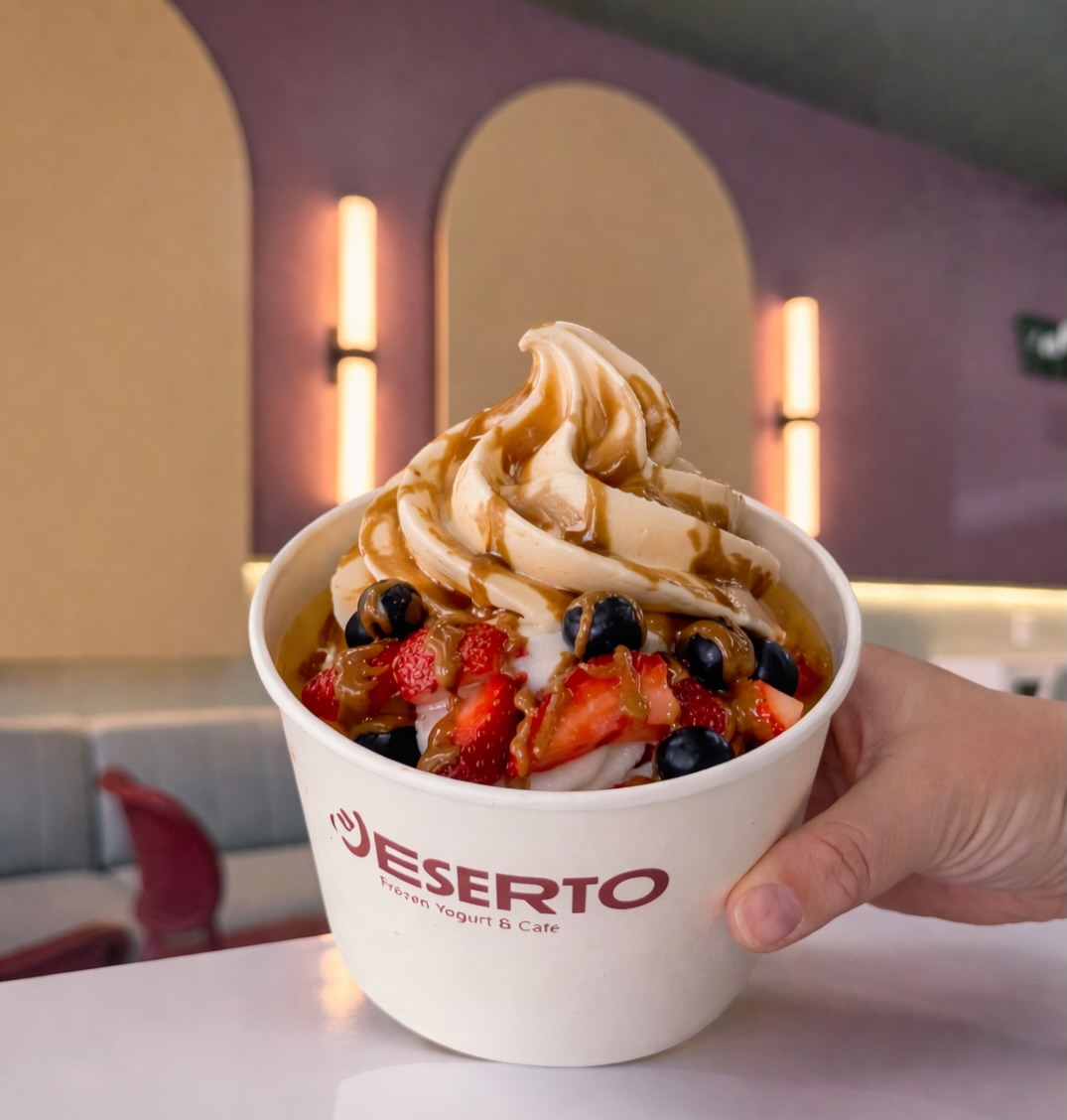 A Deserto frozen yogurt swirl with caramel drizzle, strawberries and blueberries